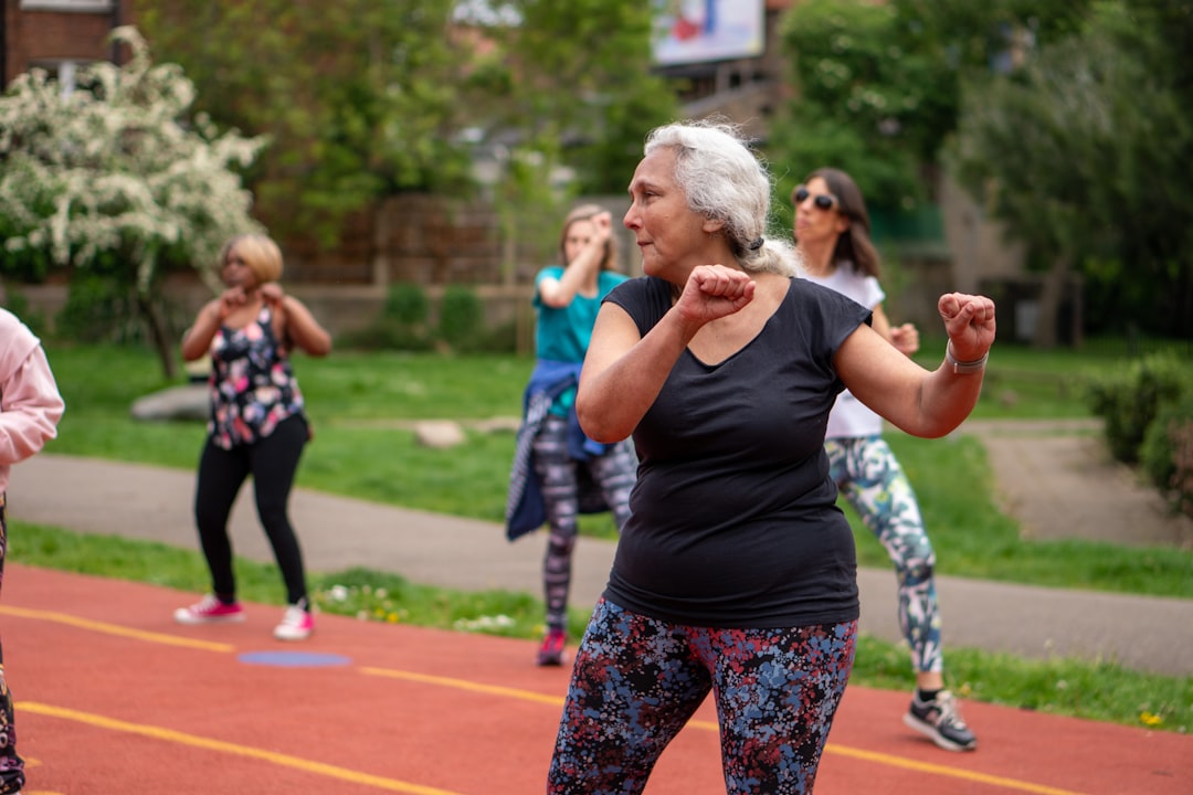 home-img An older woman does exercises at an outdoor fitness class.